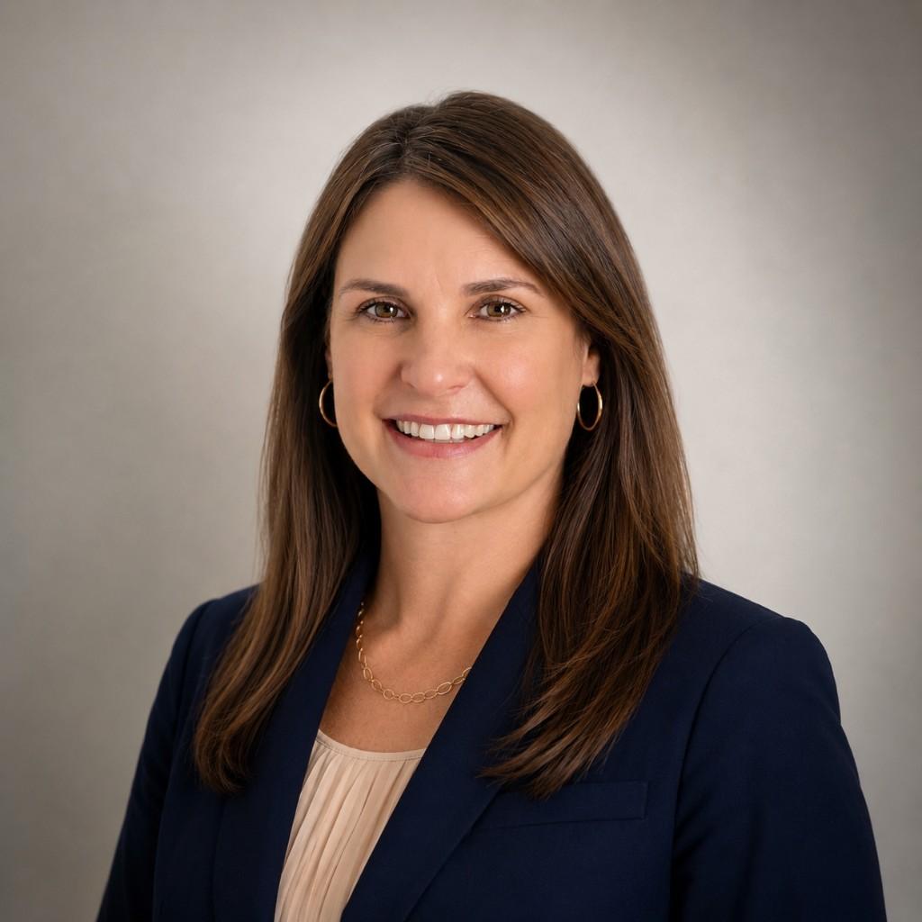 Professional headshot of Christen Paquin, founder of Paquin Law, wearing a navy blazer and smiling.